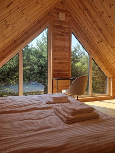 a bed in a room with a large window at Sarenka na Roztoczu in Nielisz