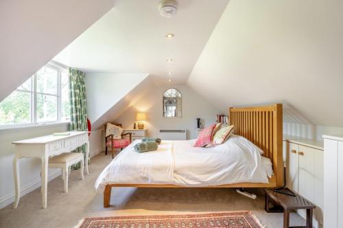 a bedroom with a bed and a desk in a attic at 2 Bed in Beaminster oc-63136 in Stoke Abbott