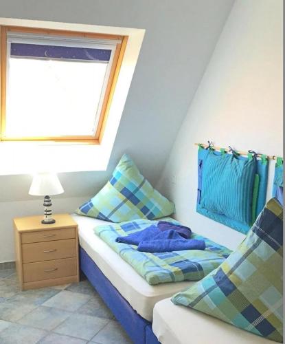 a small bedroom with a bed and a window at Residenz Seelust in Langeoog