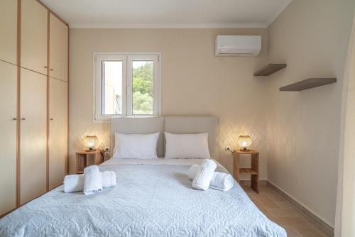 a bedroom with a large bed with two pillows at Paradise Sea View Apartments in Lygia