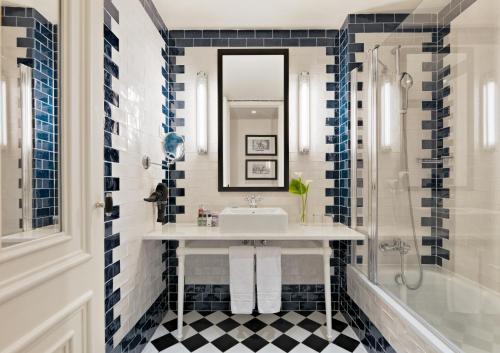 a bathroom with a sink and a mirror at H10 Duque de Loule in Lisbon