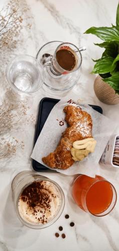 a table with a plate of food and two glasses of coffee at Dolci Momenti in Gragnano