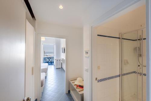 a bathroom with a walk in shower next to a bedroom at Hotel Baia Di Puolo in Massa Lubrense