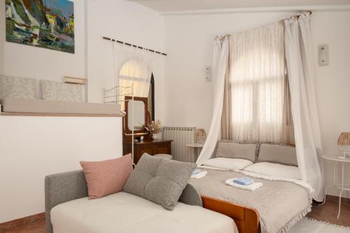 a living room with a bed and a couch at San Mauro Countryside Retreat with Restaurant & Wine Cellar in Momjan