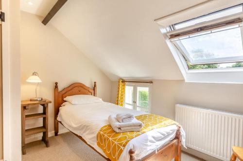 a bedroom with a bed and a window at 2 Bed in Bridport oc-dc110 in Chideock
