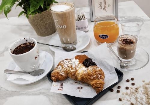 a table with a breakfast of coffee and croissants at Dolci Momenti in Gragnano