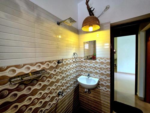 a bathroom with a sink and a mirror at Beach Way Villa in Varkala