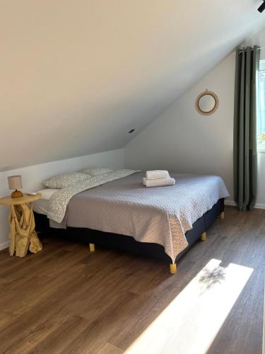 a bedroom with a bed and a wooden floor at Tavo Jūros Namai in Palanga