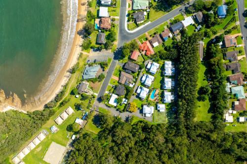 an aerial view of a residential estate next to the beach at Bec's Beach House Getaway in Batemans Bay
