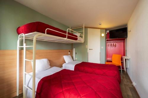 a bedroom with two bunk beds and a red bed at Premiere Classe Liege / Luik in Liège