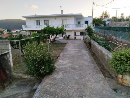 a house on a hill with a driveway at Christos House in Zárakes