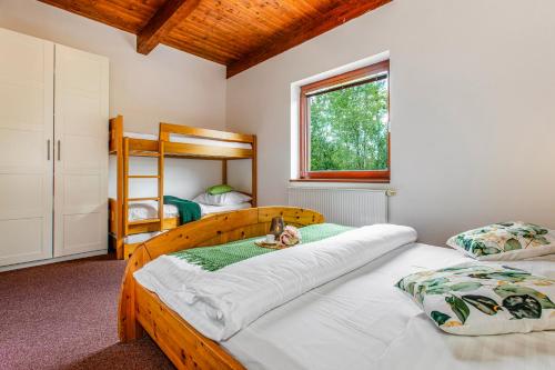 a bedroom with two beds and a bunk bed at Velvet Lipno in Lipno nad Vltavou