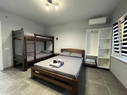 a bedroom with two bunk beds in a room at MANGO hotel in Zatoka