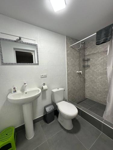 a bathroom with a toilet and a sink and a shower at MANGO hotel in Zatoka