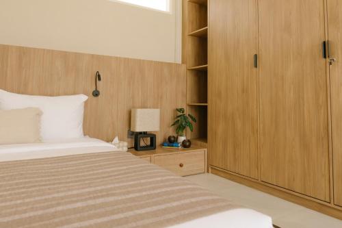 a bedroom with a bed and a wooden cabinet at Villa Drift, Balangan 1BR Surf Getaway in Bingin Beach