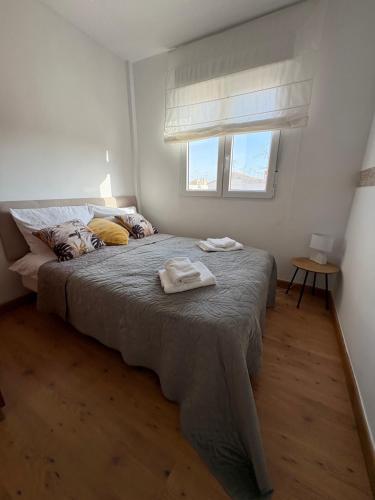 a bedroom with a bed with two towels on it at Casa del Sol - Santiago de la Ribera, San Javier, 600 m from the beach, swimming pool in San Javier