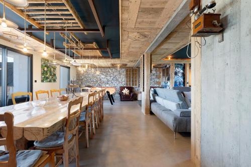 a dining room with a long table and chairs at Lodge Six De Savoie in La Toussuire