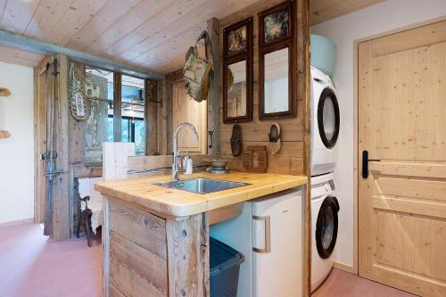 a kitchen with a sink and a stove at Lodge Six De Savoie in La Toussuire
