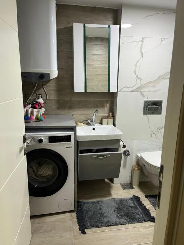 a bathroom with a washing machine and a sink at Villa Tego in Çeşme