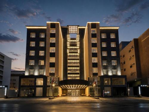 a large building with a parking lot in front of it at Garden Melenium - Jeddah in Jeddah