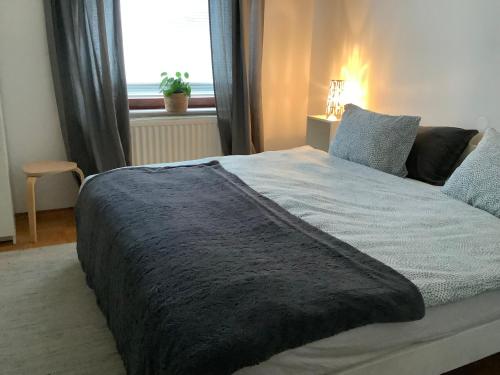 a bedroom with a large bed with a window at Elly Apartment - 20 min to Ljubljana in Kresnice