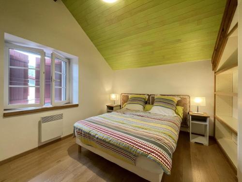 a bedroom with a bed with two tables and a window at Xola in Saint-Just-Ibarre