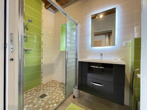 a bathroom with a glass shower and a sink at Xola in Saint-Just-Ibarre
