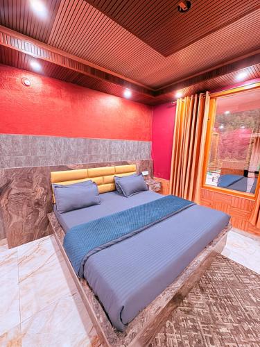 a bedroom with a large bed in a room at Being Himalayan Chojh in Manīkaran