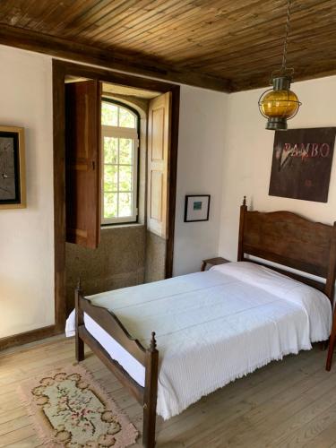 a bedroom with a large bed with a wooden ceiling at Manor House Dungeon in Chozendo