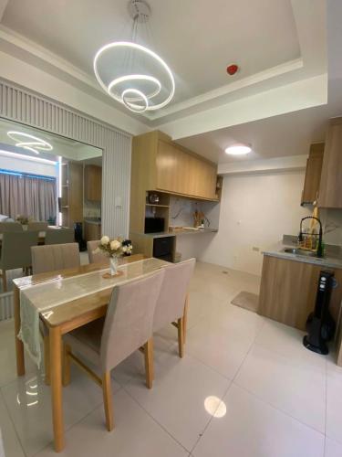 a kitchen and dining room with a table and chairs at MyHappyPlace Elements in Manila