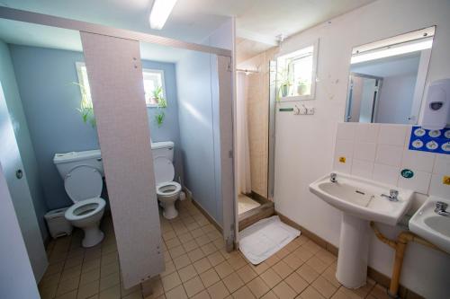 a bathroom with two toilets and a sink at Gairloch Sands Youth Hostel in Gairloch