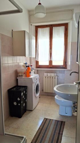 a bathroom with a washing machine and a sink at Casa Panorama in Senigallia