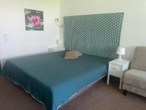 a bedroom with a blue bed and a chair at Alex in Balderschwang