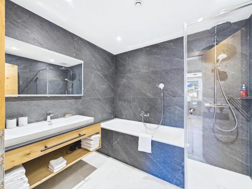 a bathroom with a sink and a shower at LUMA Stubai Aparthotel - Neueröffnung inklusive STUBAI SUPER CARD in Neustift im Stubaital