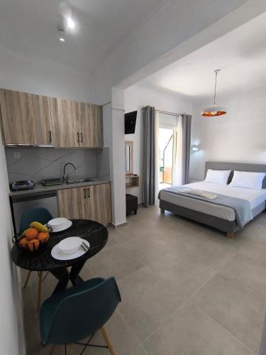 a bedroom with a bed and a table with fruit on it at Ioannis Fotinos Rooms in Lygia