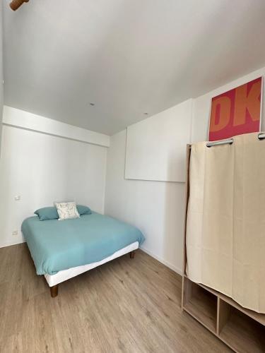 a bedroom with a bed in a room at Halles in Les Sables-d'Olonne