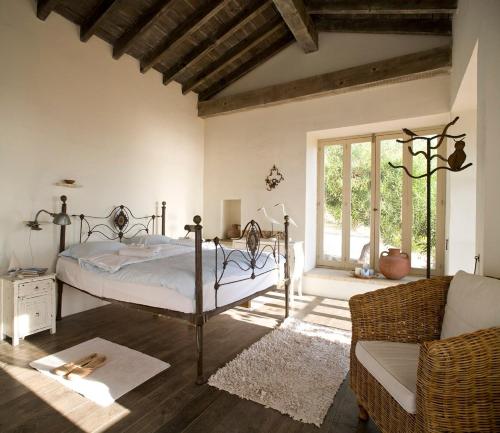 a bedroom with a bed and a couch and a window at Aphrodite's Oasis in Pomos