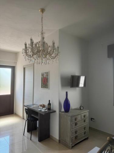 a dining room with a desk and a chandelier at Villa Ursino in Scalea