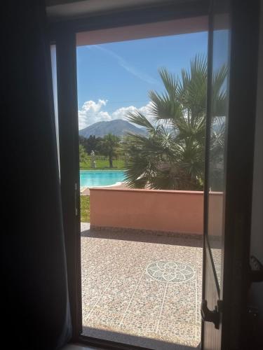 a view of a pool through a sliding glass door at Villa Ursino in Scalea