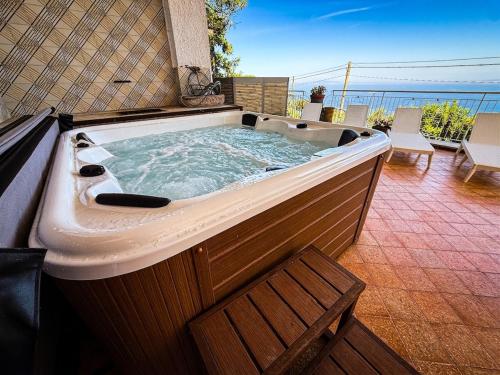 a large jacuzzi tub sitting on a patio at Villa Blu Sorrento seaview pool terrace and Jacuzzi in Sorrento