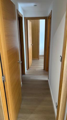 an empty hallway with two doors and a hallwayngth at Playa America 1E by YBH in Nigrán