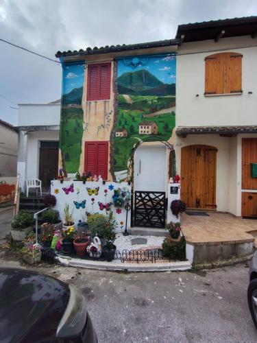 a house with a mural on the side of it at Casa Belvedere in Serradica