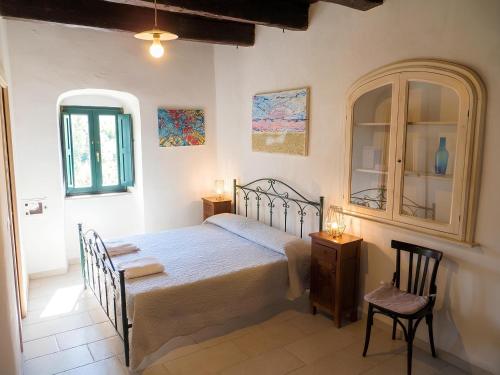 a bedroom with a bed and a table and a chair at Case Vacanza Al Borgo Antico in Vico del Gargano