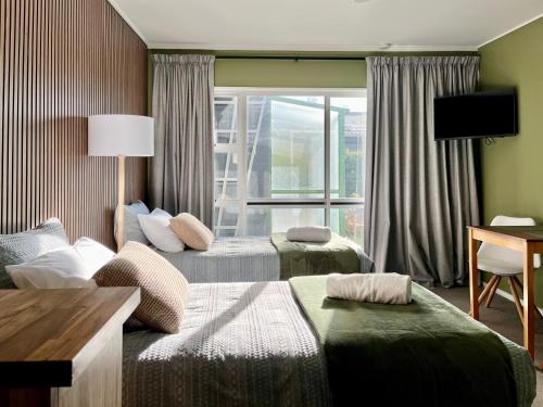 a hotel room with two beds and a window at Mt Dobson Motel in Kimbell