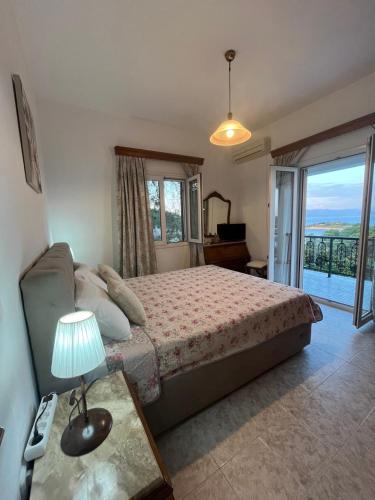 a bedroom with a bed and a view of the ocean at Marina's House in Gaios