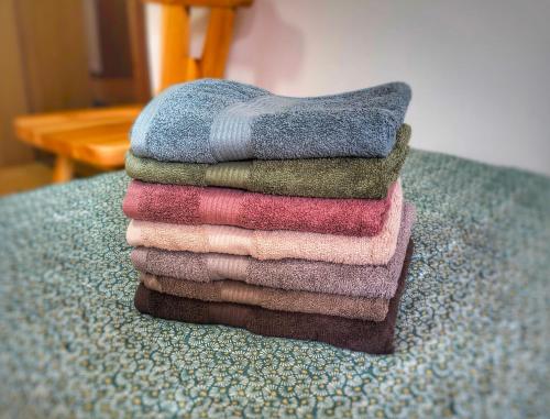 a pile of towels sitting on top of a table at Casa Pal Piccolo - Apartment with garage for bikes and fast wifi in Paluzza