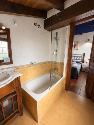 a bathroom with a bath tub and a sink at Posada El Valle - Adults Only in Suances