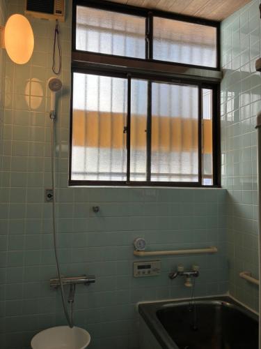 a bathroom with a toilet and a sink and a window at スペースigusa専用寝室2室に2名様3泊よりマンスリー割引がおすすめ in Tokyo
