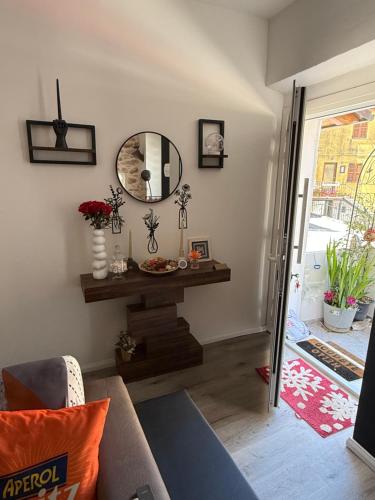a living room with a mirror and a couch at Casa Belvedere in Serradica