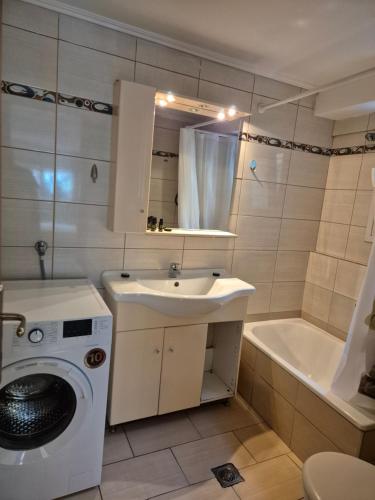 a bathroom with a washing machine and a sink at Blue studio in Kavála